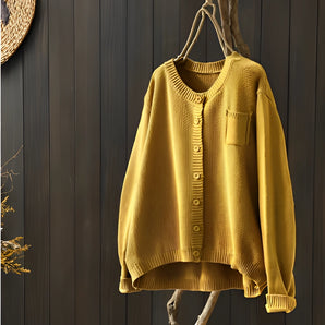 Mustard yellow ribbed knit oversized pullover sweater for women displayed on a clothes hanger, featuring long sleeves and a relaxed collar.