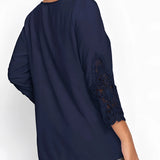 Navy blue women's blouse featuring elegant floral lace sleeves, with a round neckline and a fitted waist.