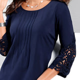 Navy blue elegant women's blouse with floral lace sleeves, featuring a dark blue color in size 2XL, showcasing a stylish design with detailed lace on the sleeves, a sophisticated collar, and a flattering fit around the waist and shoulders.