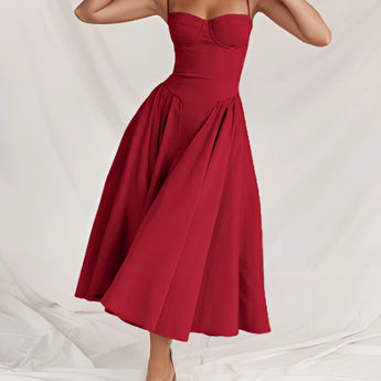 Navy blue fit and flare midi dress with spaghetti straps, perfect for summer wear; the image shows the dress being worn, highlighting its elegant one-piece design and comfortable fit.