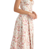 Navy blue floral A-line midi cocktail dress with spaghetti straps, featuring a fitted bodice and flowing skirt, worn by a model with styled hair.