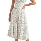 Navy blue floral A-line midi cocktail dress with spaghetti straps, highlighting its elegant design and flattering fit.