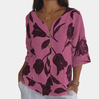 Navy blue floral linen V-neck blouse with short sleeves and a relaxed fit, designed for women's casual summer wear.