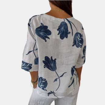 Navy blue floral linen V-neck blouse with short sleeves, showcasing a casual summer style for women.
