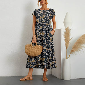 Navy blue floral midi dress with short sleeves and a round neck, designed for a casual summer look.