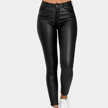 
A woman wearing black high waist stretch jeggings, showcasing a close fit around the waist, thighs, and legs, styled with a blazer.