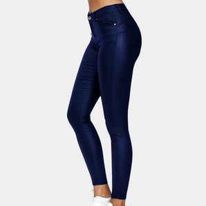 
Woman wearing navy blue high waist stretch jeggings paired with a blazer, focusing on the fit around the waist and thighs.