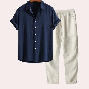 Navy blue men's button-down shirt displayed on a clothes hanger, featuring a collared neckline and buttons, paired with matching linen pants, suitable for summer, in marine blue color and size 2XL.