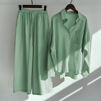 Navy Blue Men's Cotton Pajama Set on a clothes hanger showing a button-up shirt with elastic waist pants, displayed against a neutral background.
