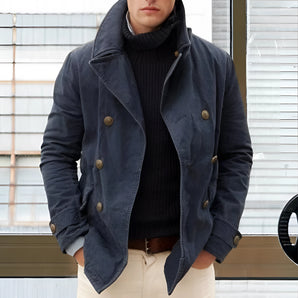 Navy blue men's double-breasted waxed jacket with a high collar, featuring long sleeves and a fitted waist, suitable for winter wear.