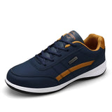 Navy blue men's dual-tone sneakers with a cushioned sole, featuring a stylish urban fashion design. The sneakers have a combination of navy and electric blue colors, suitable for sportswear and outdoor activities.