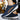 Navy blue men's dual-tone sneakers with a cushioned sole, designed for urban fashion. The athletic shoes feature a stylish blend of electric blue accents, perfect for walking and sportswear activities.