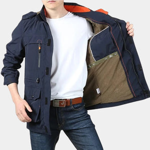Navy blue men's lightweight waterproof cargo jacket with multiple pockets, featuring a breathable and stylish design. The jacket is displayed in a marine blue color, size 3XL, and is worn over a white dress shirt.