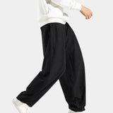 Navy blue men's linen pants with an elastic waist, designed for breathability and eco-friendliness, shown in a relaxed fit.
