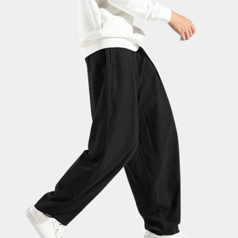 Navy blue men's linen pants with an elastic waist, designed for breathability and eco-friendliness, shown in a relaxed fit.