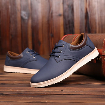 Navy blue men's low-top leather sneakers with sleek design, suitable for walking and sportswear.