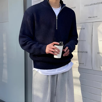 Navy blue men's ribbed zip-up sweater featuring long sleeves and a high neckline, designed for cozy fall fashion and casual wear.