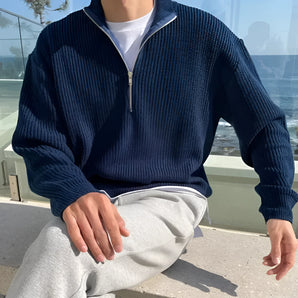 Navy blue men's ribbed zip-up sweater featuring a cozy and stylish design, perfect for fall fashion. The sweater has a high collar, long sleeves, and a textured ribbed pattern.