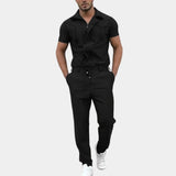 Men's short sleeve jumpsuit in navy blue, featuring a zip front, collar, and arm-length sleeves, designed for casual utility wear.