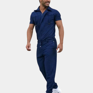 Navy blue men's short sleeve jumpsuit featuring a zip front and casual utility style, with a structured collar, fitted waist, and knee-length design.