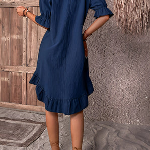 
A navy blue puff sleeve midi dress featuring a ruffle hem, suitable for spring fashion. The dress has a fitted waist, knee-length skirt, and a stylish one-piece garment design.