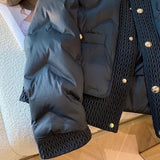 
A navy blue quilted designer puffer jacket with a high collar, designed for winter wear, displayed on a wooden floor. The jacket features long sleeves and a stylish, comfortable fit.