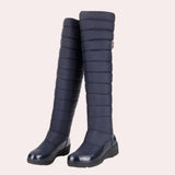 
Navy blue quilted insulated women's winter boots with a glossy toe, featuring a knee-high length and synthetic rubber material, shown in a marine blue color, size 42.