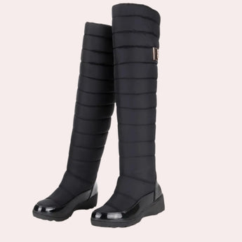 Navy blue quilted insulated women's winter boots featuring a glossy black toe, shown in size 42.