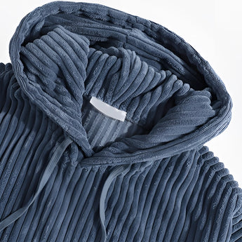 Navy blue ribbed corduroy pullover hoodie with a high collar, featuring long sleeves and a textured pattern.