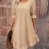 Woman wearing a khaki 3XL one-piece ruffle dress with round neck and short sleeves, standing and showcasing the casual summer chic style.