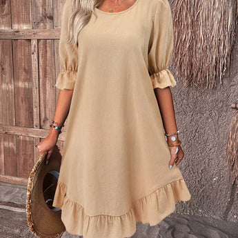 Woman wearing a khaki 3XL one-piece ruffle dress with round neck and short sleeves, standing and showcasing the casual summer chic style.