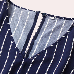 Navy blue striped V-neck sleeveless blouse designed for an office casual look, featuring a symmetrical pattern with shades of blue.