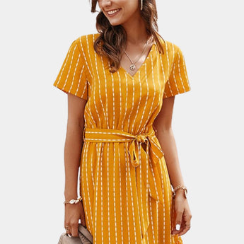Navy blue striped V-neck sleeveless blouse worn by a smiling person, showcasing the shoulder and neck details, suitable for office casual wear.