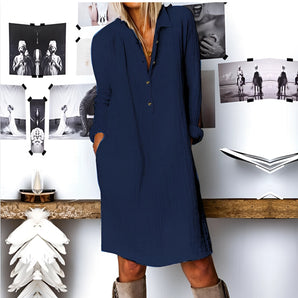 Woman wearing Navy Blue V-Neck Long Sleeve Mini Shirt Dress, standing with hands on waist, showcasing boho chic fall fashion.