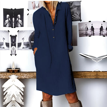 Woman wearing Navy Blue V-Neck Long Sleeve Mini Shirt Dress, standing with hands on waist, showcasing boho chic fall fashion.