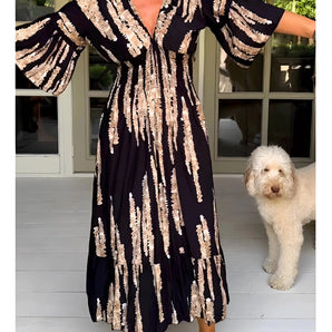 Navy blue V-neck sequin maxi dress with elegant long sleeves, featuring a fitted waist and shimmering design suitable for formal occasions.