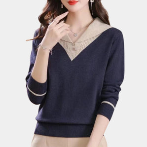 Navy blue V-neck sweater featuring a delicate lace collar and striped cuffs, highlighting the shoulder and sleeve details in the knitwear design.