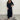 Navy blue wide-leg jumpsuit with 3/4 sleeves, designed for plus-size evening wear, featuring a tailored waist and a classic neckline.
