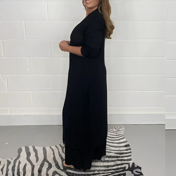 Navy blue wide-leg jumpsuit with 3/4 sleeves, designed as plus-size evening wear featuring a one-piece garment style and defined waist.