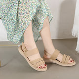 Navy blue women's comfort sandals with braided strap design, lightweight and stylish, worn on a model's feet.