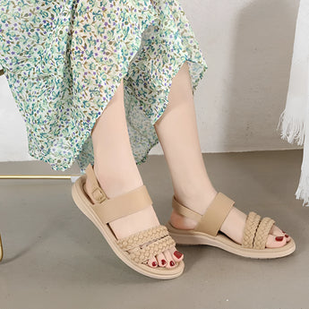 Navy blue women's comfort sandals with braided strap design, lightweight and stylish, worn on a model's feet.
