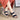 Navy blue women's comfort sandals with a braided strap design, shown on a model wearing a red dress.