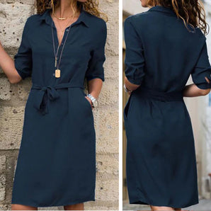 
Navy blue women's knee-length belted shirt dress with 3/4 sleeves, featuring a collared neckline and designed for a day dress style.