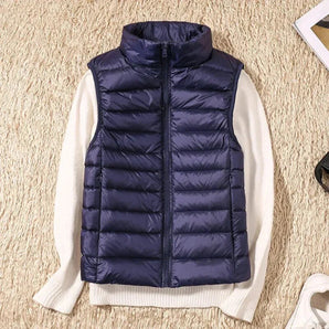Navy blue women's lightweight quilted puffer vest with a high collar, shown in a dark blue color, size 4XL.