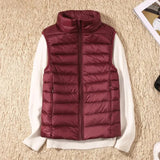 Navy blue women's lightweight quilted puffer vest with a high collar, shown in a burgundy red color, size 4XL. 