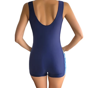 Navy blue women's sleeveless scoop back bodysuit shown on a model, highlighting the fit around the shoulders, arms, and waist.