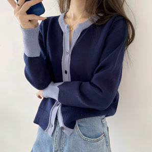 Navy blue women's V-neck cardigan made of lightweight wool, featuring a button-up front and long sleeves.