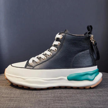 Navy blue zipper wedge sneakers with a chunky platform, featuring a black color variant, displayed on a grassy surface.