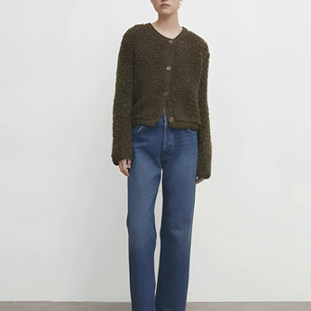 Navy bouclé jacket for women, featuring a chunky knit texture, styled as a winter cardigan. The jacket showcases a tailored fit with long sleeves, shoulder details, and a combination of casual and elegant elements, suitable for pairing with jeans or dress pants.