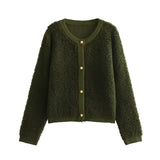 
A green women's chunky knit bouclé jacket featuring a rectangular shape with a textured pattern. The outerwear includes a collar and long sleeves, designed for winter wear.